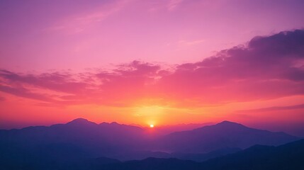 Obraz premium A stunning sunset sky filled with vibrant orange and red hues, transitioning into softer purple tones as it meets the horizon. Silhouettes of distant mountains create a peaceful landscape,