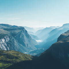 Fototapeta premium Breathtaking View of Remote Valley Surrounded by Majestic Mountains Under Clear Blue Sky with Soft Mist in the Air Capturing Nature's Tranquility and Beauty