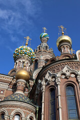Fototapeta premium Against the backdrop of the blue sky, the domes of the Church of the Resurrection of Christ on the Blood in St. Petersburg look especially elegant