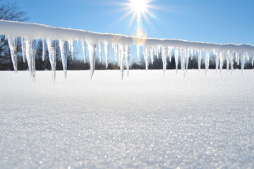 A frozen landscape with icicles hanging from a wire