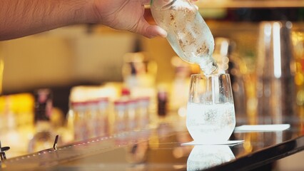 Closeup bartender hand in poring fresh soda gas texture into glass of drink advertisement serving customer at beverage bar counter luxury pub for welcome impression greeting guess service. Vinosity.