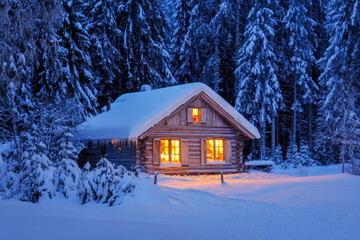 Cozy snow-covered cabin in winter forest with warm glowing lights at twilight