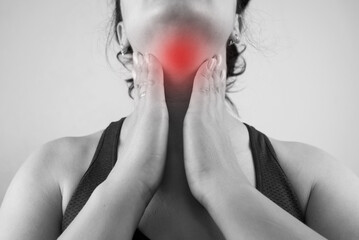 Sore throat. Close up of beautiful young woman touching her sore neck. Healthcare and medicine...