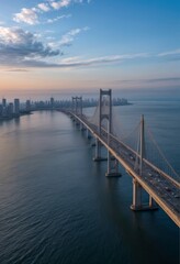 Obraz premium An expansive bridge stretches across a vast body of water under a calm blue sky.