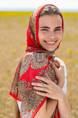 Close up portrait of a young woman in a traditional patterned headscarf