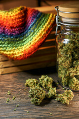 Medical cannabis on a wooden table, green dry buds, cbd oil, healing tincture, cannabinoids
