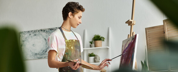 A talented young woman creates an expressive painting at home, enjoying her art and hobby in peace.