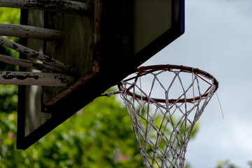 Vibrant basketball hoop against a clear blue sky, inviting players to shoot for the hoop on a sunlit day, capturing the essence of outdoor sports and active lifestyle