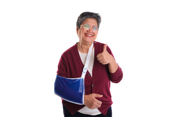 A smiling woman with a blue arm sling giving a thumbs up, representing positivity despite...
