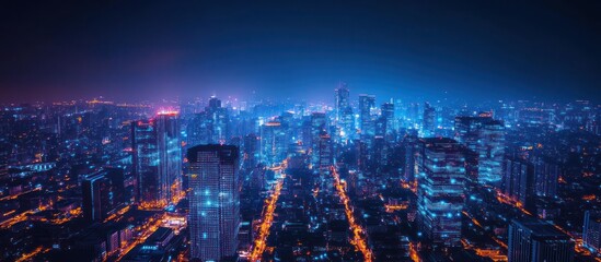 Fototapeta premium Blurred aerial night view of a city skyline with skyscrapers.