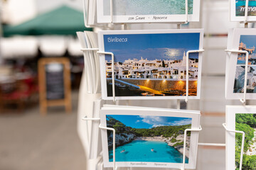 Rack of postcards featuring famous locations in Menorca, Spain