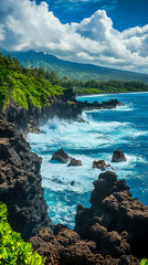 Rocky coastline with turquoise water and white waves crashing against the shore, under a clear blue sky with puffy white clouds.