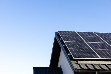 Modern house with solar panels stand-alone photovoltaic plant system on household metal sheet...
