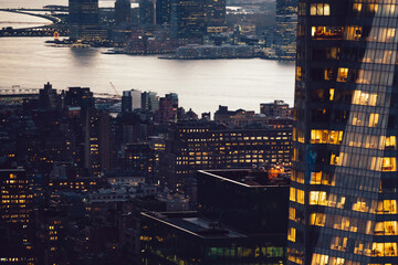 Aerial view of various high Manhattan skyscrapers buildings with lighted windows located in New...