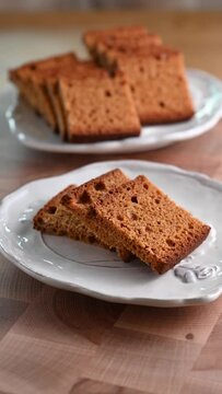 Traditional Swiss spiced bread, Biberfladen, sliced and served on plates. This aromatic bread, filled with honey and nuts, offers a cozy, festive feel, perfect for winter holiday promotions, social