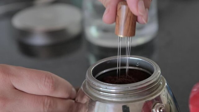 CloseUp of Coffee Maker Preparation &ndash; Brewing Process with Minimalist Design. moka pot coffee maker being prepared. Ideal for content related to coffee, home brewing, or minimalist kitchen tools.4k 