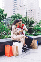 Urban focused multiethnic consumers using smartphone on street