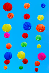 Colorful lantern hanging over street, traditional Asian decor.