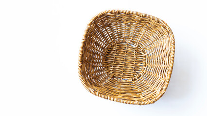 Fototapeta premium Empty wicker basket on a white background. Top view.