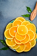 Cut orange slices on a plate ready to eat. Close up macro, top view.