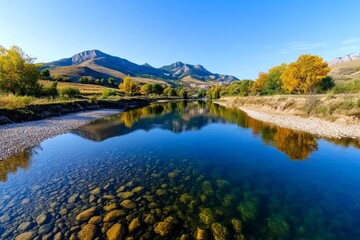 Fototapeta premium Landscape of a calm river flowing through a valley, with reflections of trees and hills on the water