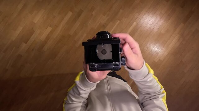 pov First person view Photographer using vintage twin lens reflex camera 
