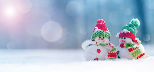 Merry Christmas and happy new year greeting card .Two cheerful snowman standing in winter Christmas landscape.