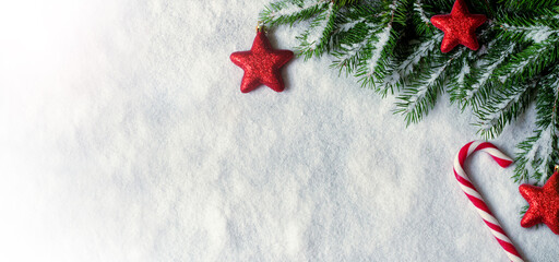 Christmas background with red decorations on white snow background. Top view.