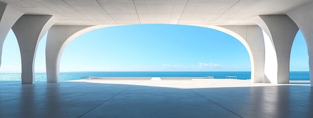 Fototapeta premium A wide-angle view of an empty concrete floor with white columns and a bridge over the ocean in front