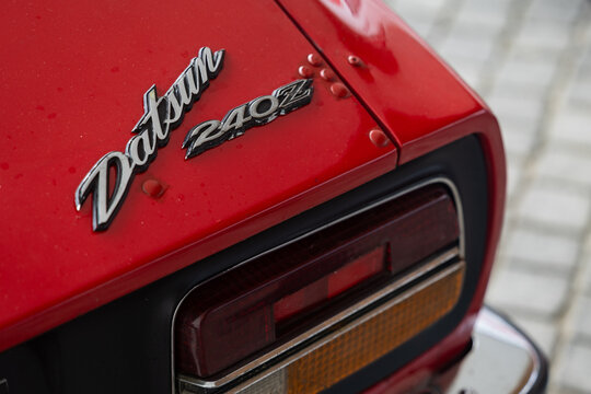 Close-up of the rear badge and taillight on a red Datsun 240Z
