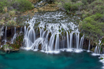 Fototapeta premium Nature’s symphony in full display. The breathtaking beauty of Huancaya Falls is like stepping into a dream. Nor Yauyos Lima Peru