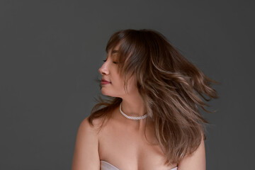 Fototapeta premium Attractive woman with stylish haircut on grey background
