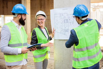 Team of young architects and business partners discussing and arguing during a meeting on a construction site.