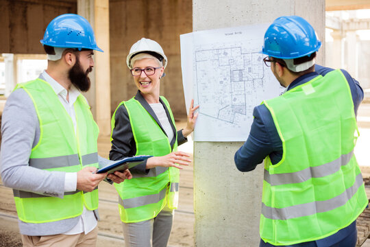 Team of young architects and business partners discussing and arguing during a meeting on a construction site.