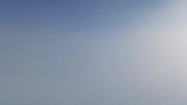 Winter A tranquil video of winter fog merging with a clear blue sky, creating a serene and ethereal atmosphere. Perfect for use in relaxation content, weather-related media,or as a backdrop for winter