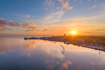 Aerial drone image of town Terschelling and the Wadden sea at sunset