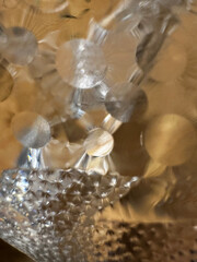 A close-up image of a textured surface featuring circular and starburst patterns, creating a...