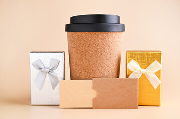 Eco-Friendly Coffee Cup with Gift Boxes Minimalist Holiday Gift Concept. tylish image featuring an eco-friendly cork coffee cup surrounded by elegantly wrapped gift boxes, set against a soft 