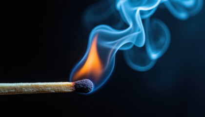 A matchstick burning with a smoky blue flame in a studio setting
