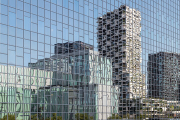 Reflections of high apartments and office buildings around the train station in Utrecht.