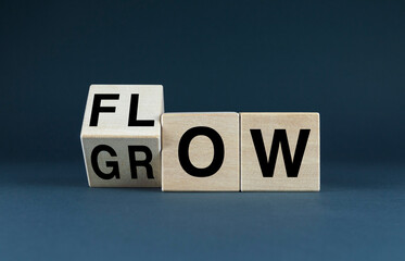 Wooden blocks spell out the words FLOW and GROW