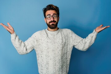 Naklejka premium Young Man Confused. Portrait of Hispanic Man with Beard Looking Confused over Blue Background