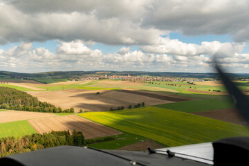 Fototapeta premium Rural scenery in Aalen in Germany seen from a small plane