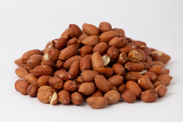 Fototapeta premium Raw Peanuts with Skin on White Background