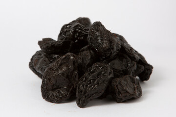 Pile of Dried Prunes Isolated on White Background