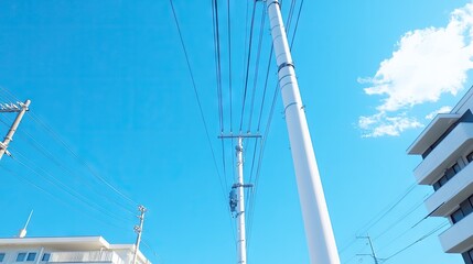 Overhead power lines stretch across a clear blue sky, connecting communities and enabling electric trains to glide smoothly through the landscape