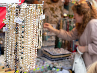 Beads and necklaces made of natural pearls and mother-of-pearl in a street shop of oriental jewelry.