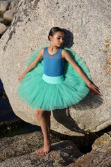 Young brunette ballet dancer by the ocean