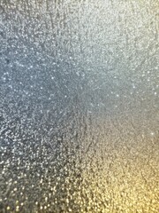 Sparkling gold and silver glitter texture with a festive shine