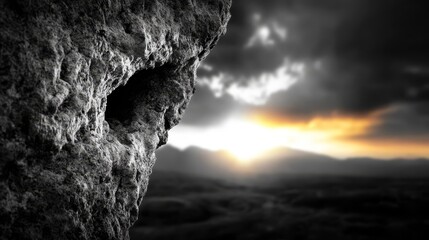 A black and white photo of a rock formation with a hole in it